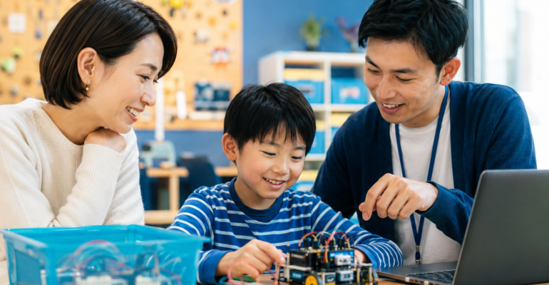 Parent observing a child during a coding class trial with an educator
