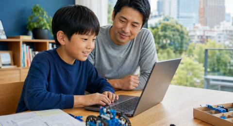 Child balancing coding screen time with robotics and offline project planning