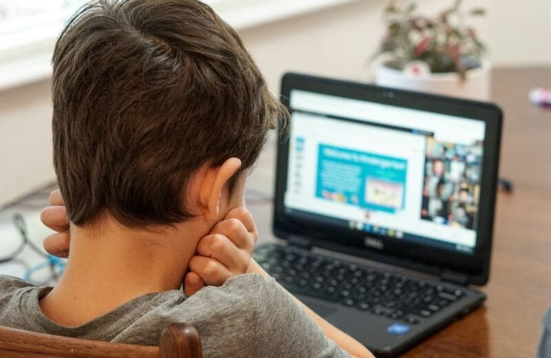 Child working on a coding project on a laptop