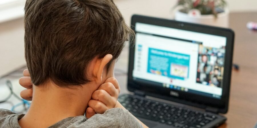 Child working on a coding project on a laptop