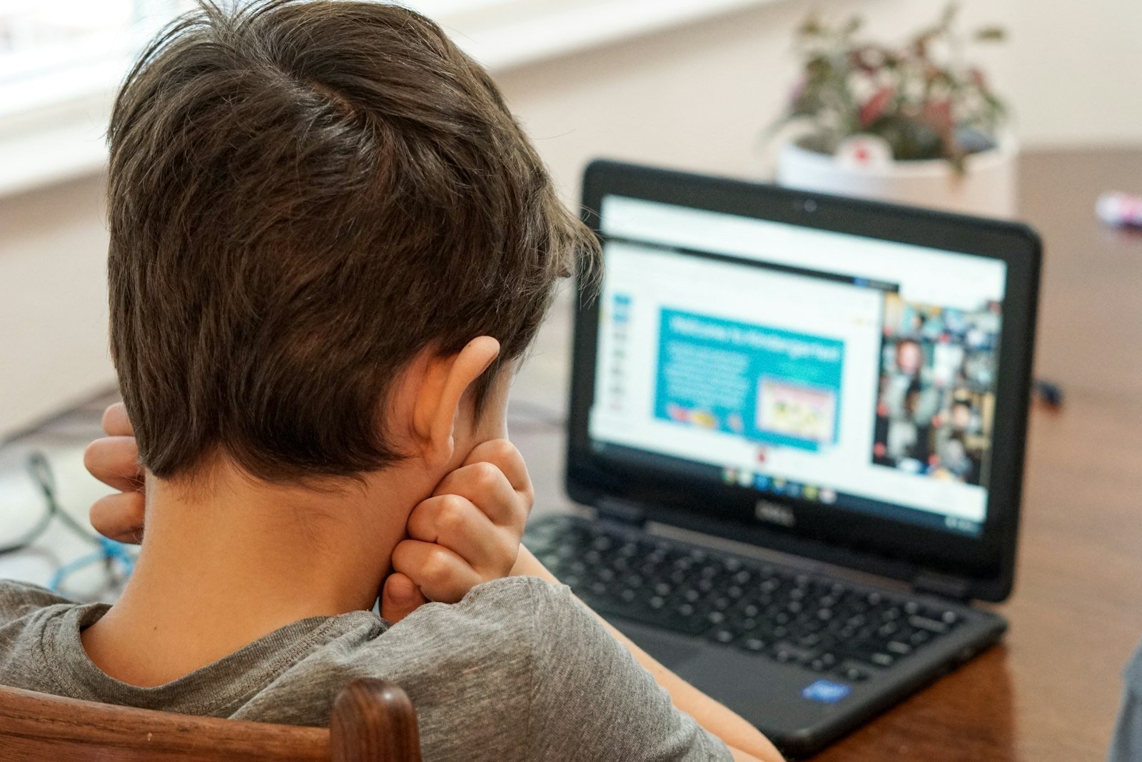 Child working on a coding project on a laptop