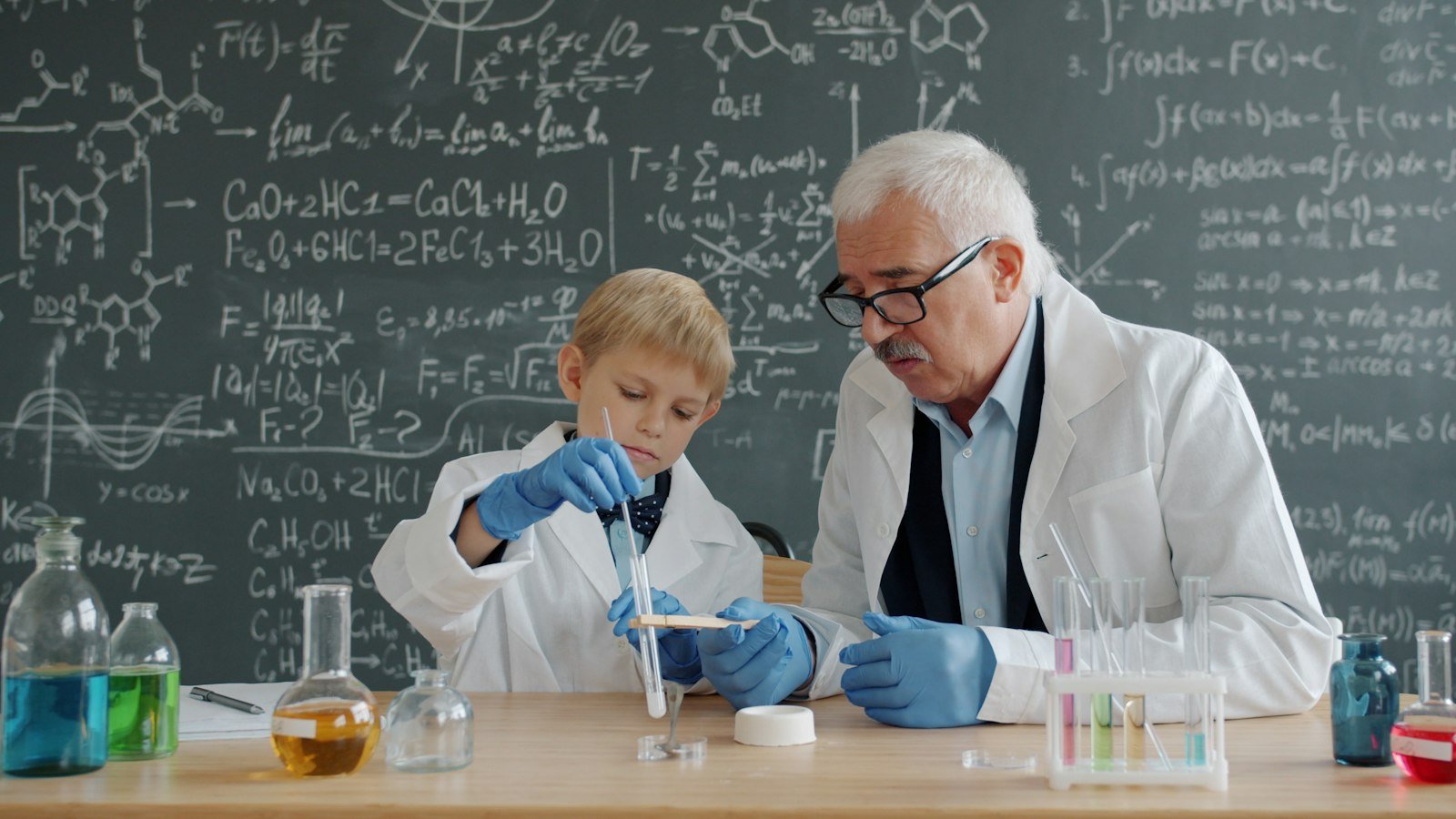 Teacher and student conducting a science experiment in a workshop setting