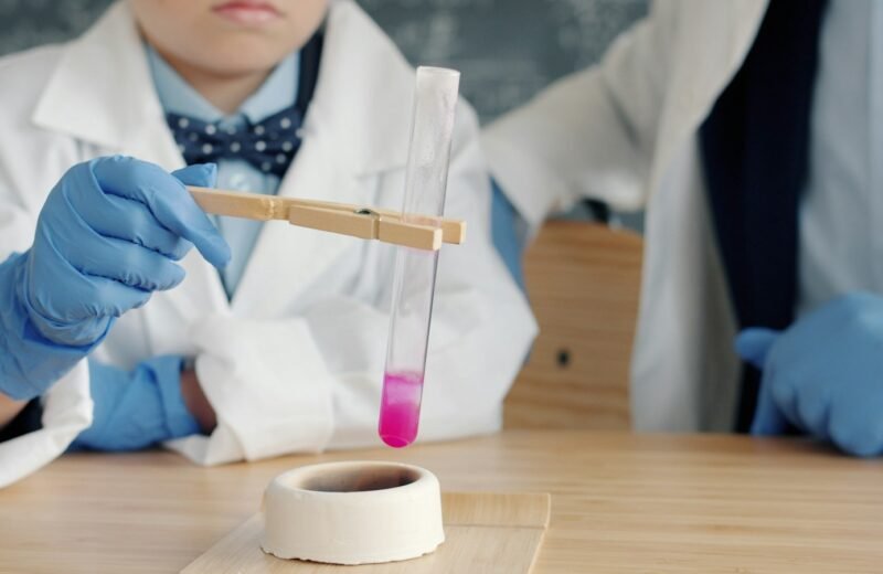 Children in lab coats conducting a science experiment as part of STEM education